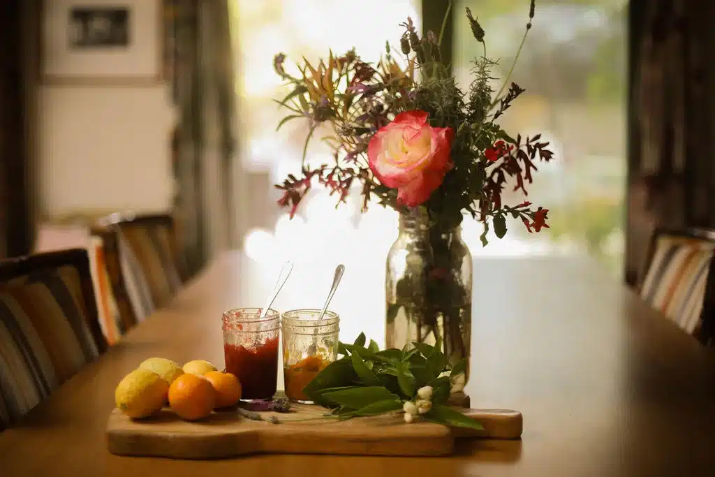 Dining table with fresh citrus and herbs, set up for cooking after shopping at Ojai grocery stores