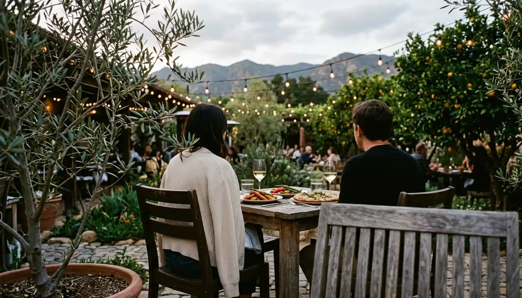 Diners on an Ojai restaurant patio on a mild evening, a layering tip for your Ojai weekend getaway